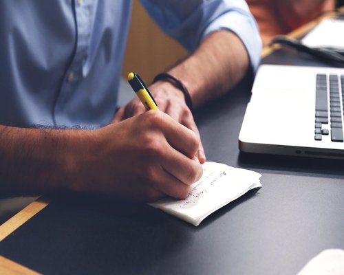 Coworking space in Mexico with people collaborating and taking notes